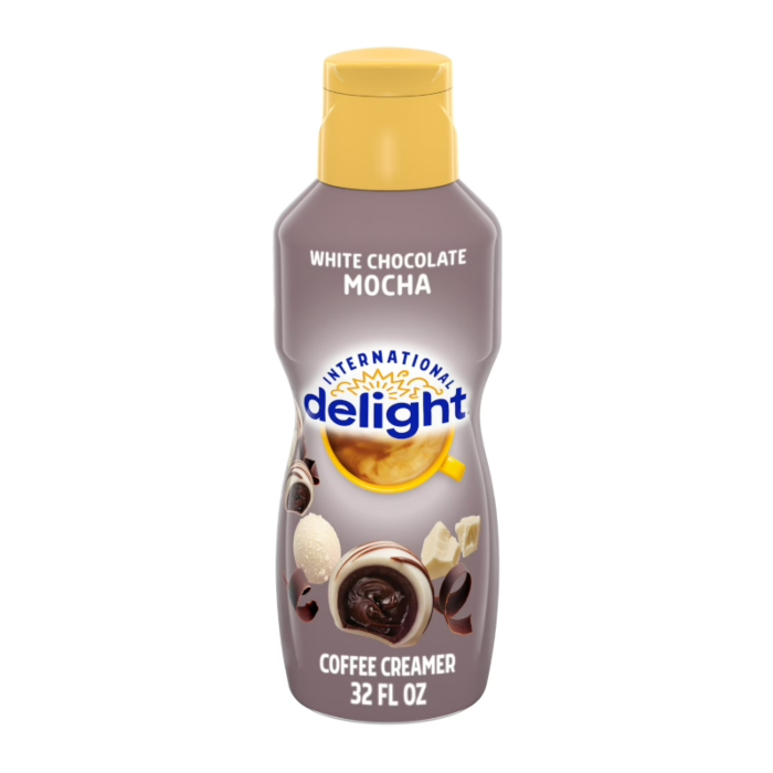Front of International Delight Coffee Creamer White Chocolate Mocha bottle showing logo, coffee cup illustration, and flavour details (946ml)