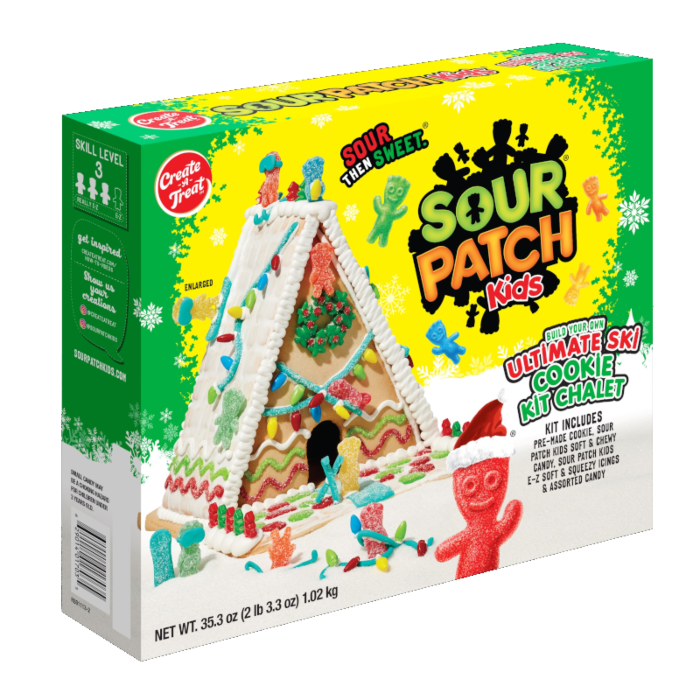 Front of Sour Patch Kids Build Your Own Ski Chalet Cookie Kit packaging showing vibrant colours, cookie chalet design, and assorted candy pieces (1002g kit)