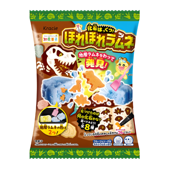 Front of KRACIE Dig Dig Ramune Fossils Candy Kit (21g) showing playful dinosaur designs, a digging tool, and vibrant blue candy.