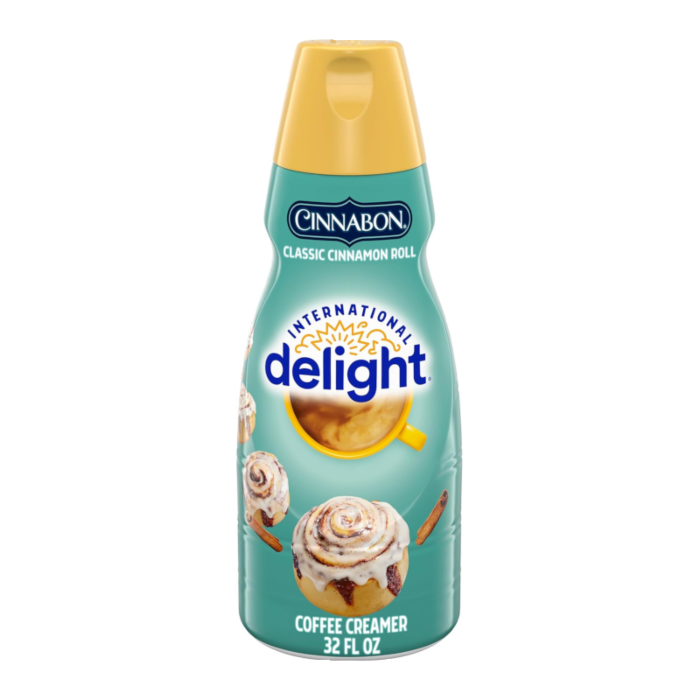 Front of International Delight Coffee Creamer Cinnabon bottle showing logo, cinnamon roll imagery, and 946ml label