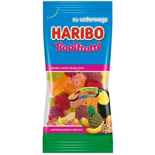 Front of Haribo TropiFrutti bag showing the logo, bright tropical fruit shapes, and image of colourful gummy sweets (75g pack)