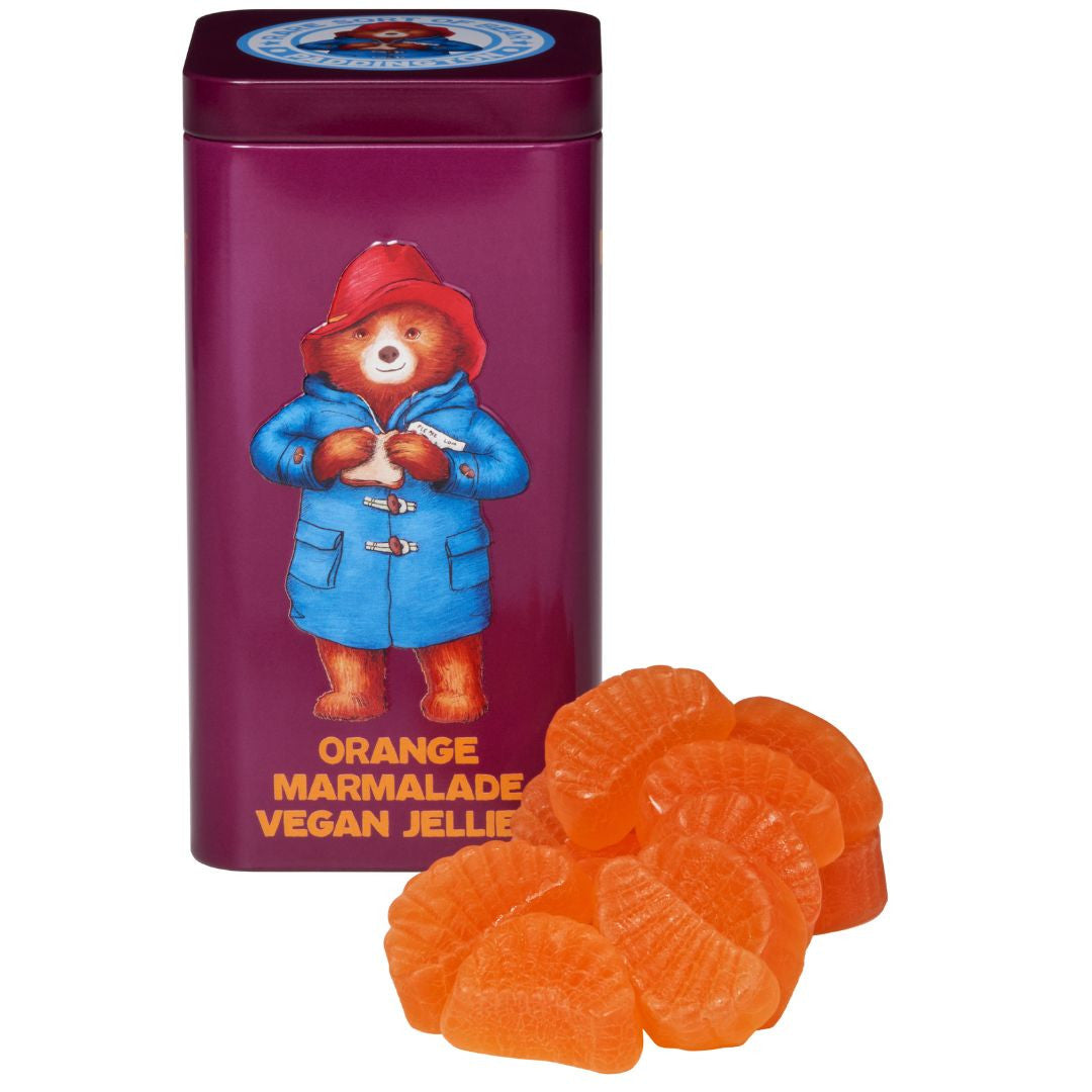Front of Paddington Bear Orange Marmalade Jelly Sweets Tin showing Paddington Bear illustration, orange marmalade jelly sweets, and 140g pack size.