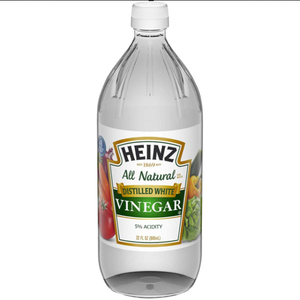 Front of Heinz Distilled White Vinegar bottle showing clear liquid, logo, and label details, 946ml pack size with 5% acidity.