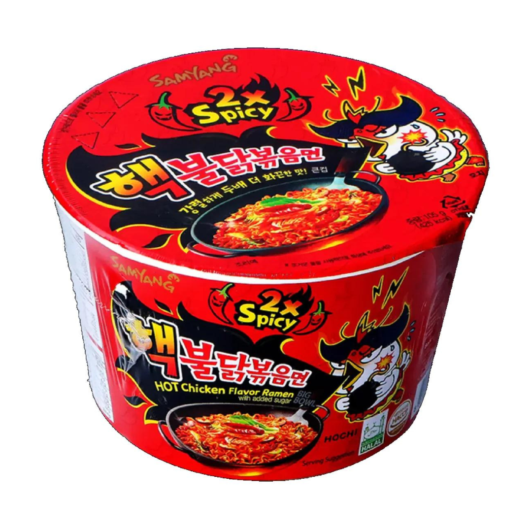 Front of Samyang Buldak Ramen 2X Spicy Flavour Big Bowl showing bright red packaging, hot chicken flavour label, and a bowl of noodles (105g)