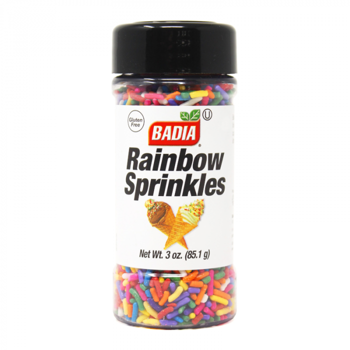 Front of Badia Rainbow Sprinkles container displaying colourful sprinkles, brand logo, and 85.1g pack size.
