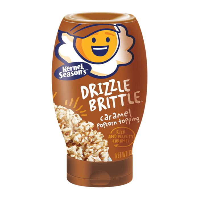 Front of Kernel Season's Caramel Drizzle Brittle bottle featuring a brown label with the product name, caramel popcorn topping imagery, and 371g pack size