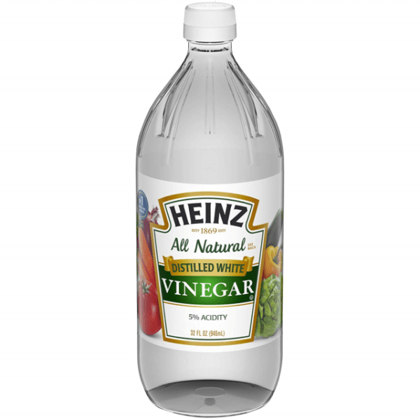 Front of Heinz Distilled White Vinegar bottle showing clear liquid, logo, and label details, 946ml pack size with 5% acidity.
