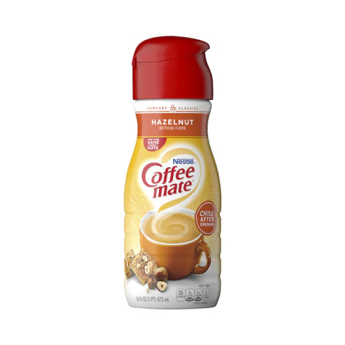 Front of Coffee-Mate Hazelnut Liquid Creamer bottle showing the red cap, hazelnut flavour label, and a visual of a cup of coffee (473ml)