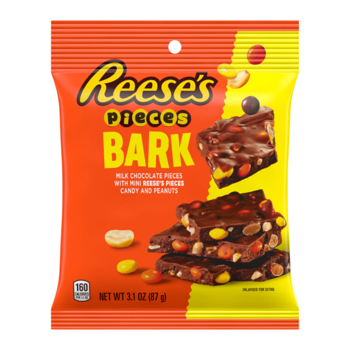 Front of Reese's Pieces Bark bag featuring bright red and orange design, showcasing milk chocolate bark with mini Reese's Pieces and crunchy peanuts (87g pack)