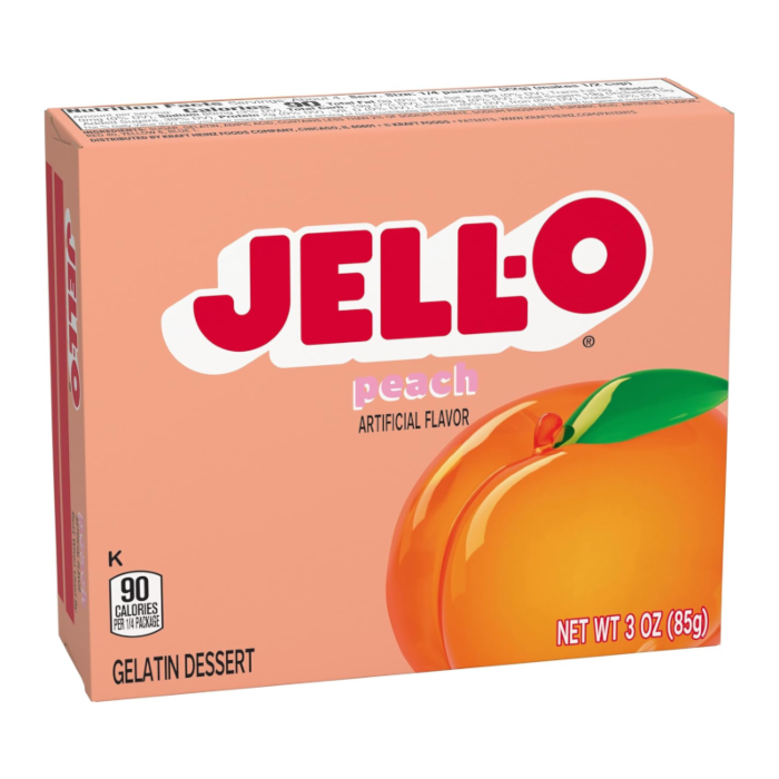 Front of Jell-O Peach Gelatin box featuring the logo, vibrant peach graphics, and a clear display of the 85g pack size.