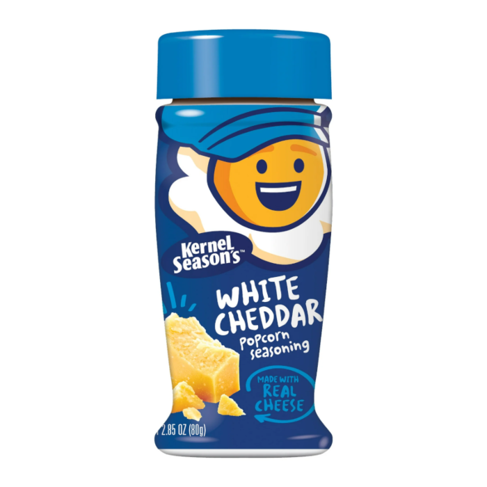 Front of Kernel Season's White Cheddar Popcorn Seasoning bottle featuring blue cap, smiley character logo, and yellow cheese imagery (80g pack)