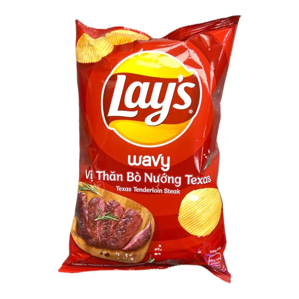 Front of Lay's Texas Tenderloin Steak bag showing bold logo, wavy crisps, and an image of steak on a wooden board (30g pack).