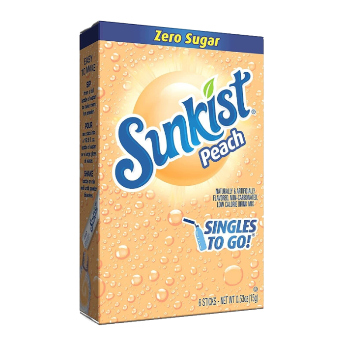 Front of Sunkist Peach Zero Sugar Singles To Go box featuring the Sunkist logo, peach flavour label, and details of the 15g pack containing six sticks.