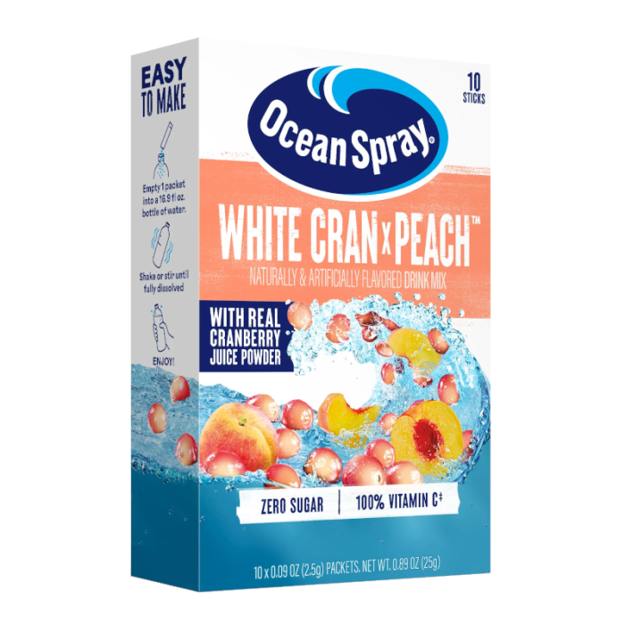 Front of Ocean Spray White Cran x Peach drink mix box showing brand logo, vibrant peach and cranberry imagery, and details for 10 stick packets (25g)
