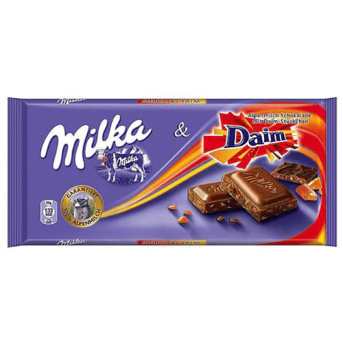 Front of Milka Daim chocolate bar packaging showing the Milka logo and Daim pieces, 100g pack size with vibrant purple colour.