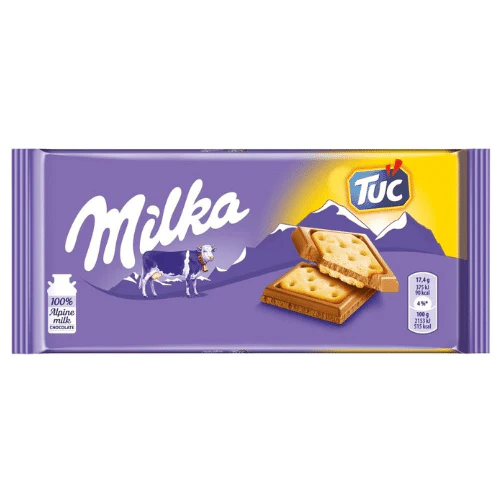 Front of Milka Tuc pack displaying the brand logo, biscuit sandwich image, and the pack size of 87g.