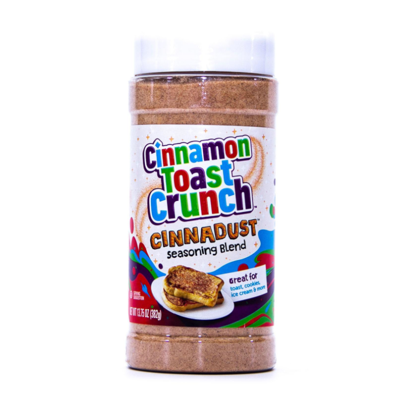 Front of Cinnamon Toast Crunch CINNADUST Seasoning Blend container showing colourful logo, seasoning blend title, and image of cinnamon toast (382g pack)