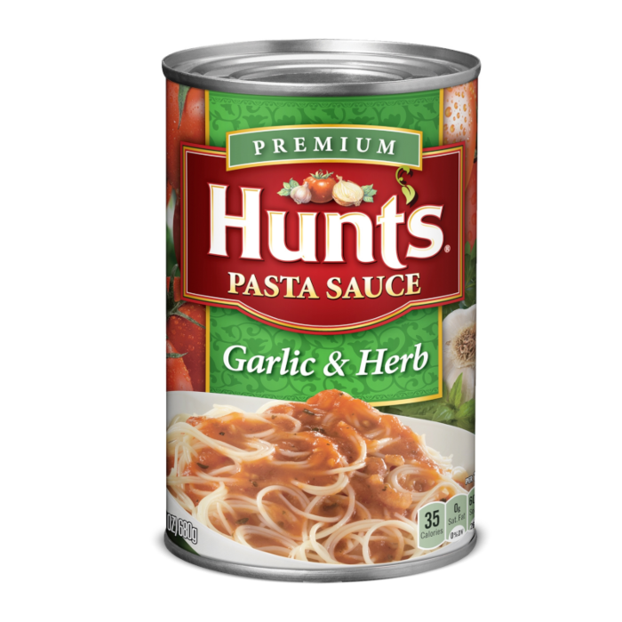 Front of Hunts Pasta Sauce Garlic & Herb can displaying rich green and red colours, featuring garlic and herb imagery and serving suggestion with pasta (680g pack)