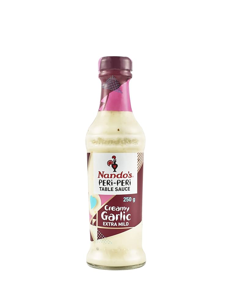 Front of Nando's Creamy Garlic Sauce Extra Mild bottle featuring the logo, creamy texture, and 250g label.