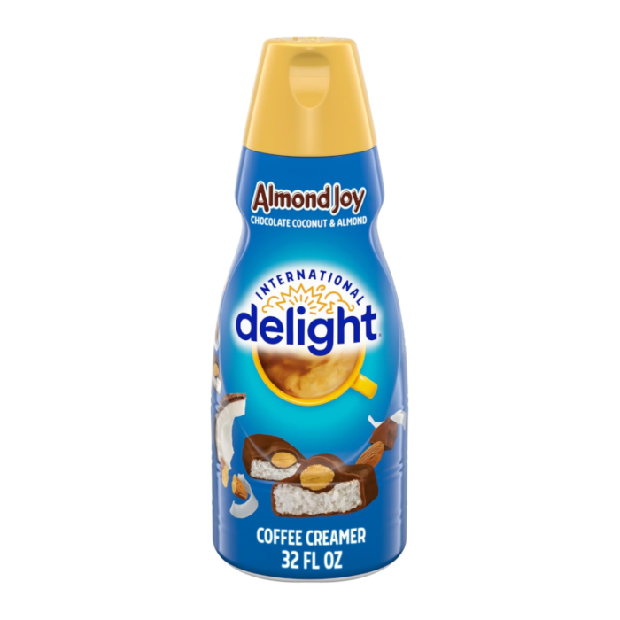 Front of International Delight Coffee Creamer Almond Joy (946ml) featuring a vibrant blue design with chocolate, coconut, and almond imagery.