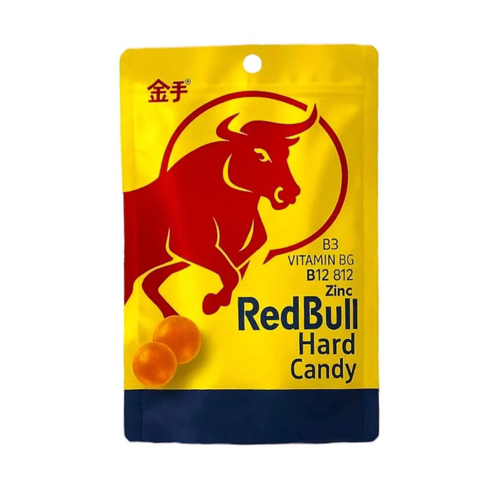 Front of Red Bull Hard Candy packaging featuring a red bull logo, bold lettering, and orange candy pieces in a 22g pack.