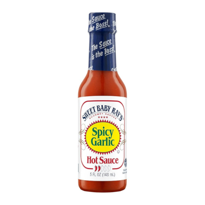 Front of Sweet Baby Ray's Spicy Garlic Hot Sauce bottle displaying bold logo, spicy garlic flavour label, and 148ml size